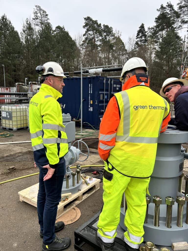 Engineers working at a geothermal wellhead, geothermal wells on site